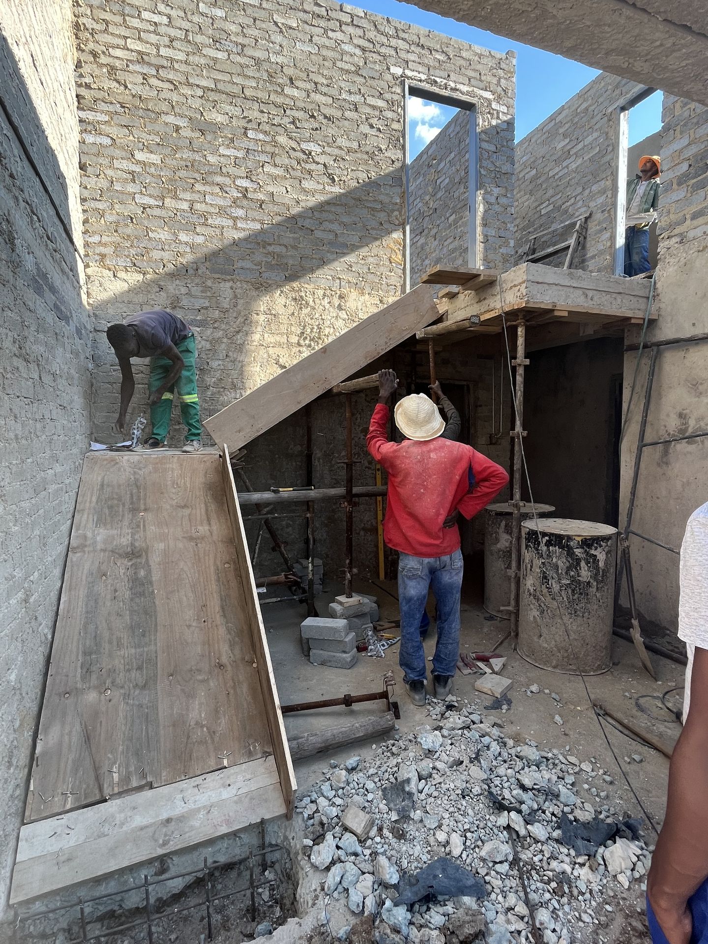 Gebisa Projects worker fixing brickwork on a house under construction