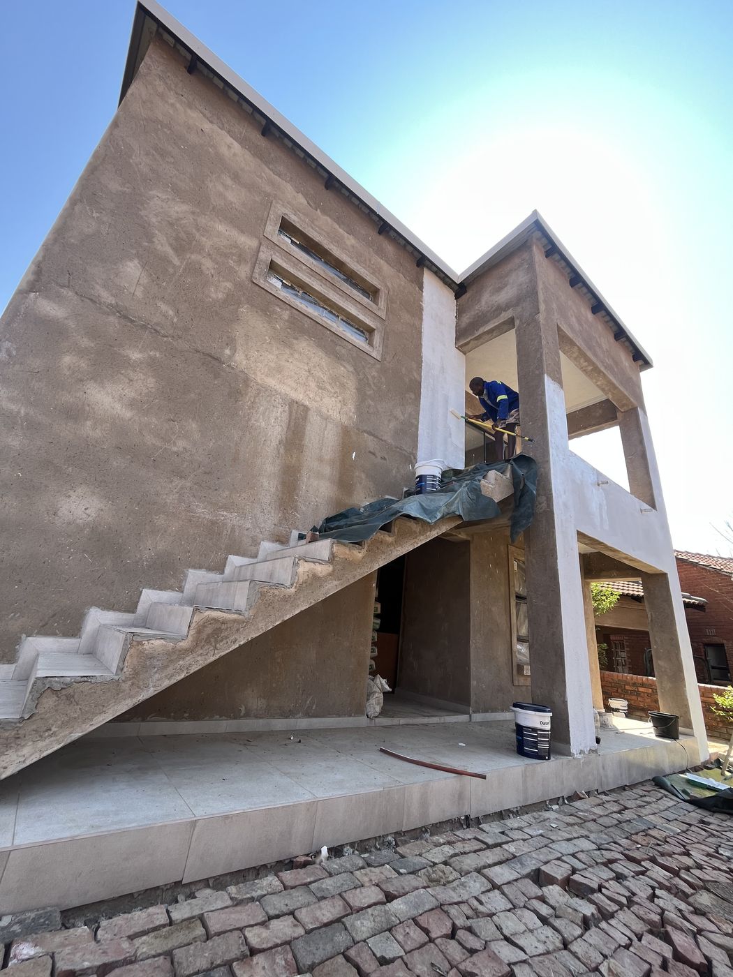 Gebisa Projects team rendering and painting a two-storey house exterior