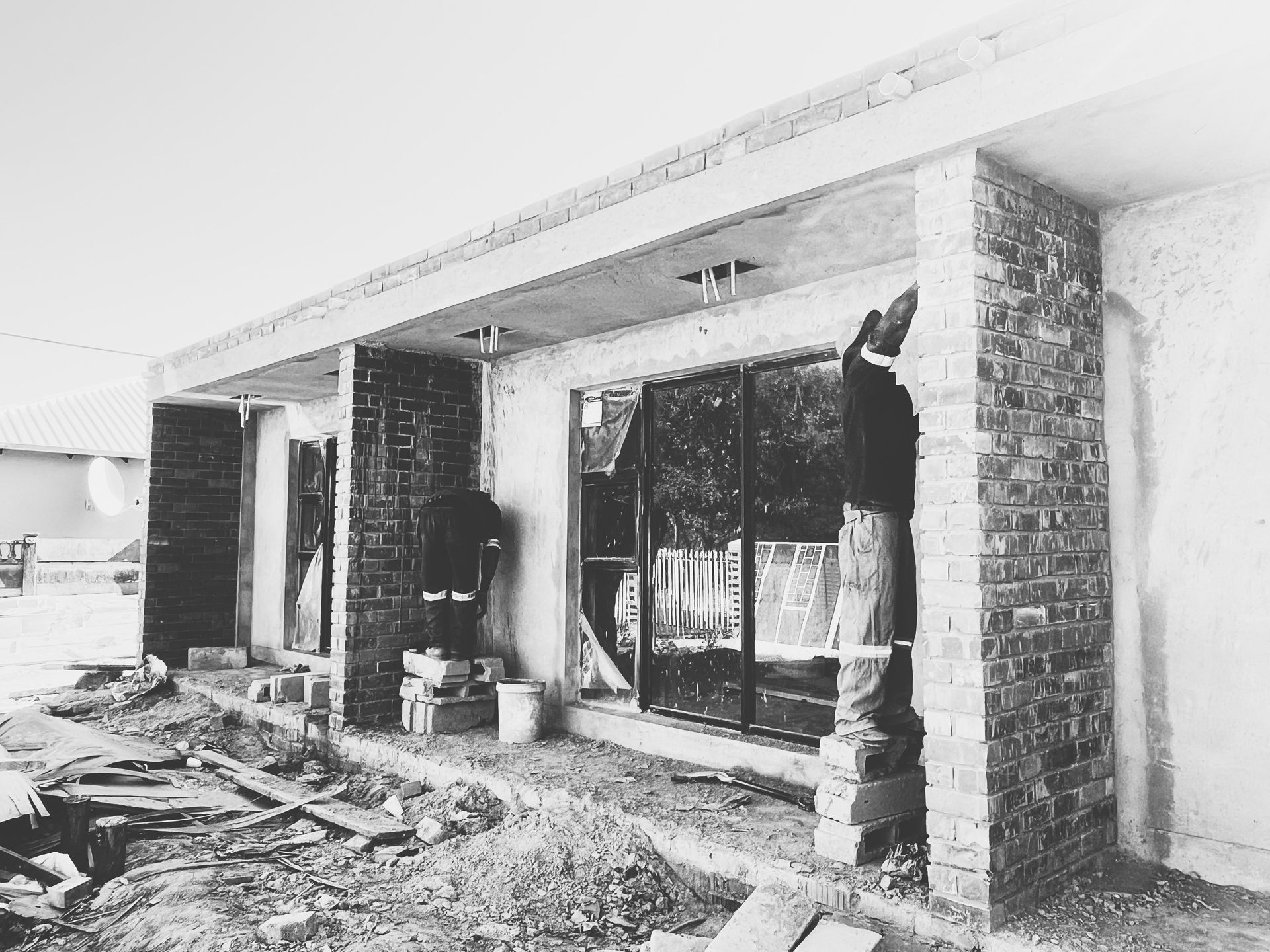 Gebisa Projects site team working on a brick house under construction