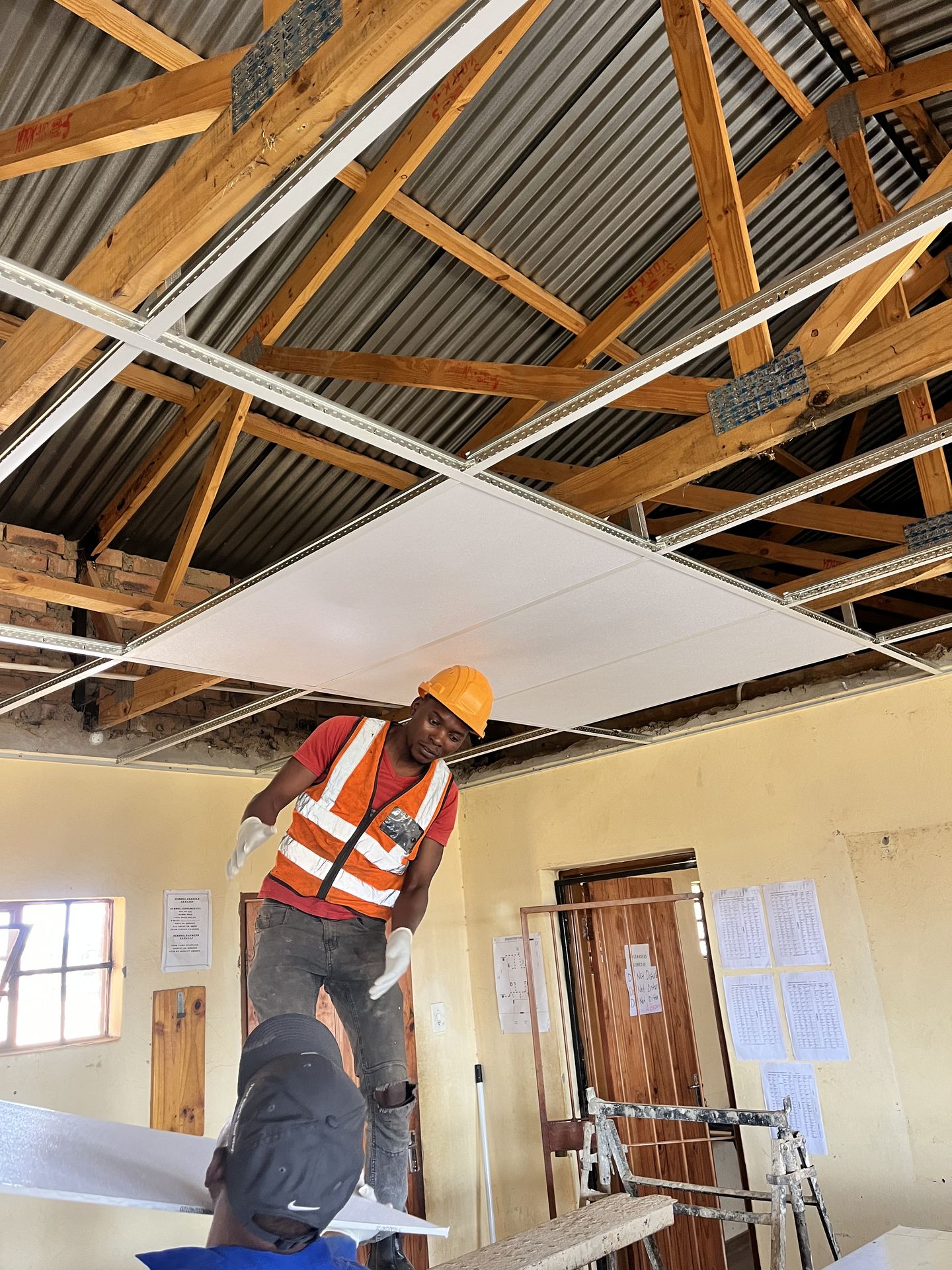 Gebisa Projects technician installing a suspended ceiling