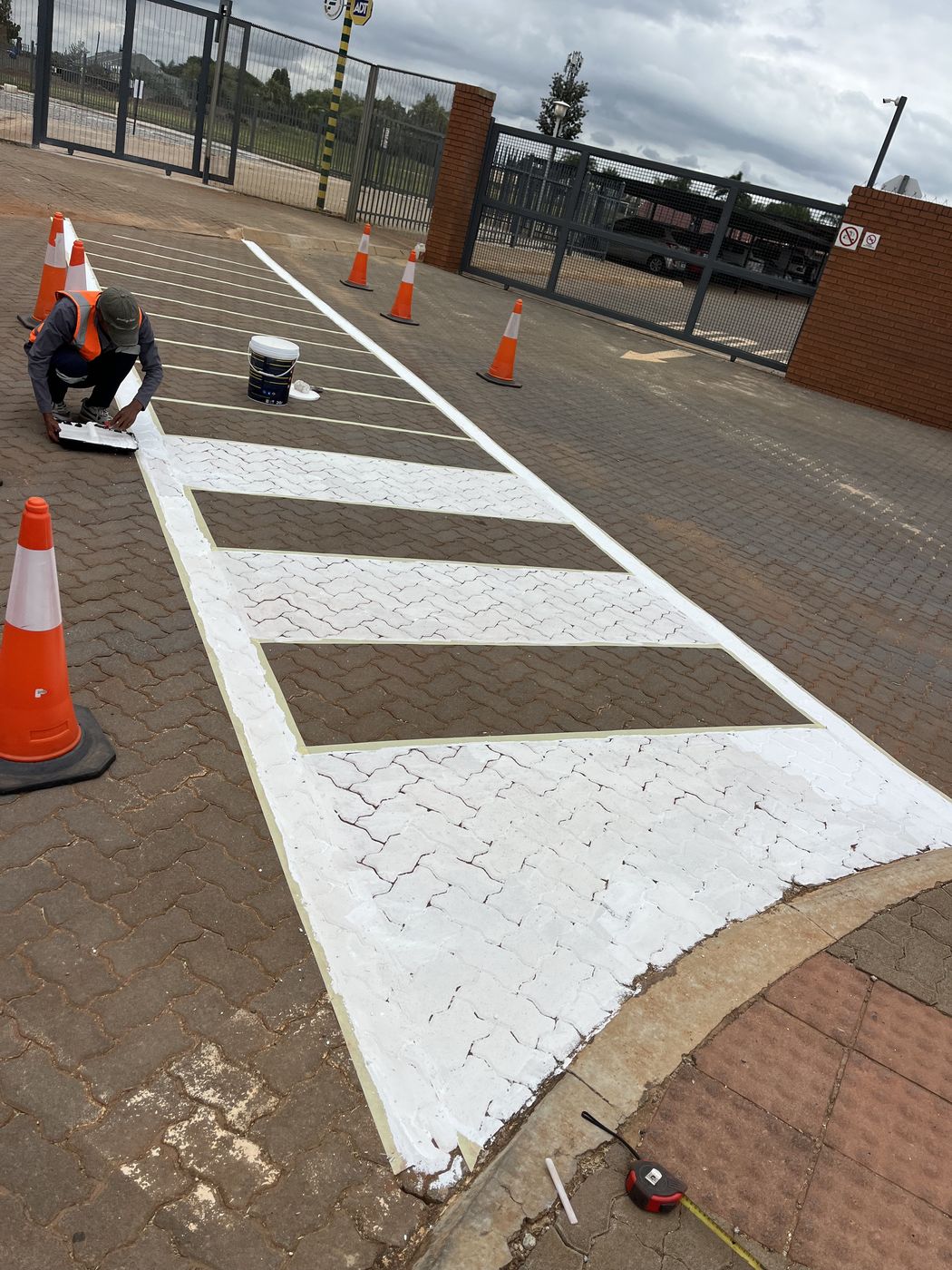 Gebisa Projects technician line-marking a paved parking area