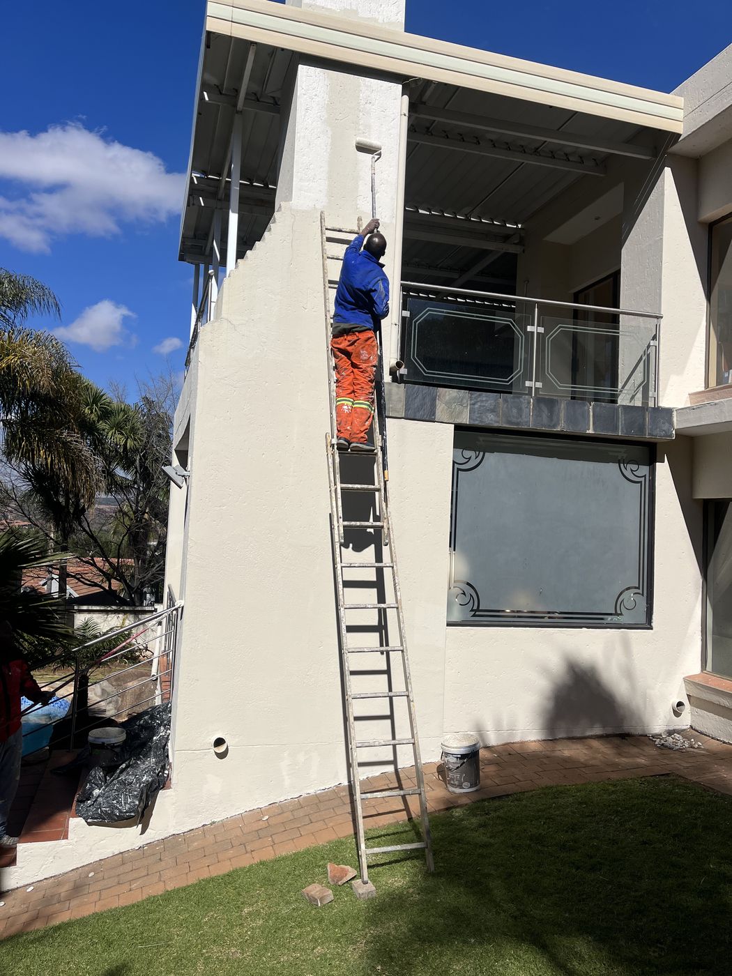 Gebisa Projects technician painting the exterior wall of a house