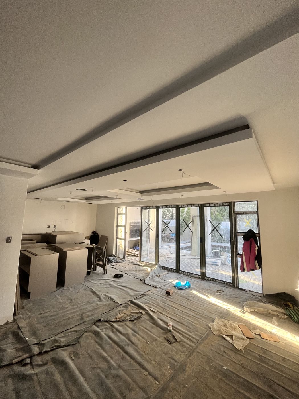 Gebisa Projects interior fit-out showing a bulkhead ceiling and kitchen cabinetry installation on a residential build